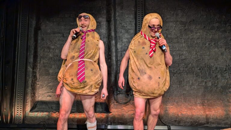 Two men dressed as potatoes, wearing ties and sunglasses